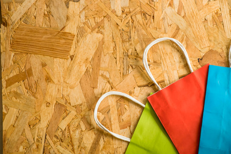 Flat lay paper shopping bag  on a wooden backgroundの写真素材