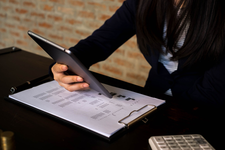 Businesswoman using tablet to the situation on the market value , Business concept.の写真素材