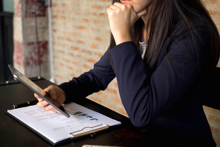 Businesswoman using tablet to the situation on the market value , Business concept.の写真素材