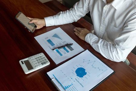 Businessman using smartphone to the situation on the market value , Business concept.の写真素材