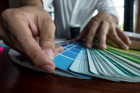Graphic designer choose colors from the color bands samples for design .Designer graphic creativity working concept.の写真素材