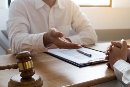 Lawyer present client with contract papers on the table in office. consultant lawyer, attorney, court judge, concept.の写真素材