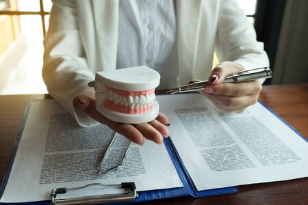 The dentist has shown the use of dental tools with  samples tooth model in the clinic. Orthodontic...
