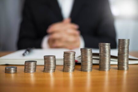 Businessman working with income statement document on the wood table.Business concept.の写真素材