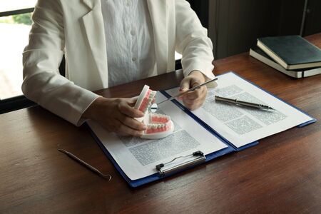 The dentist has shown the use of dental tools with  samples tooth model in the clinic. Orthodontic...