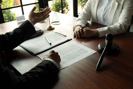 Lawyer working with contract client on the table in office. consultant lawyer, attorney, court judge, concept.の写真素材
