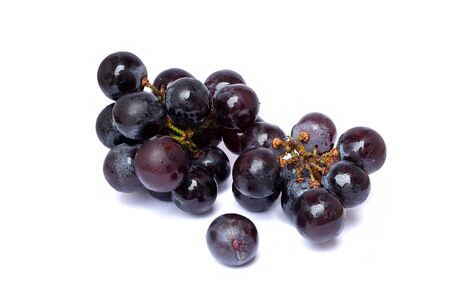 Close up of brunches black seedless grapes that isolated on a white background. Grapes that high vitamin B and Flavanoids for health.の写真素材