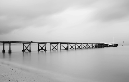 Black and white of pier on a cloudy dayの写真素材