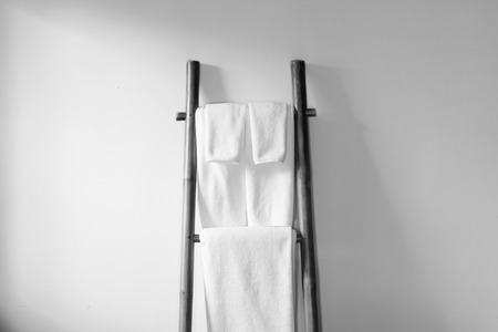 Towels hanging on the bamboo hanger and ready to useの写真素材