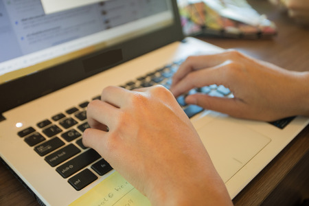 Hands are placed on a computer keyboardの写真素材