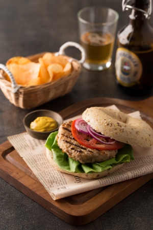 Closeup of a burger with fries and a beerの写真素材