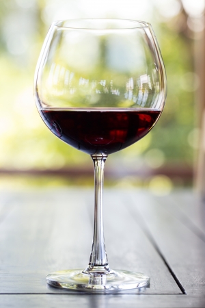 Glass of Red Wine on wood tableの写真素材