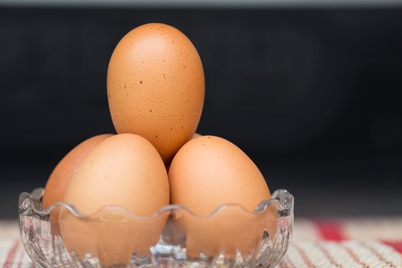 Chicken brown eggs, closeup view backgroundの写真素材
