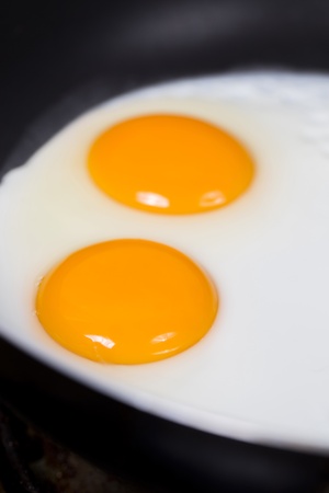 fried eggs in a frying panの写真素材