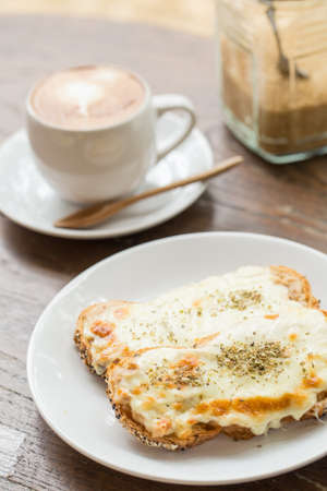 A grilled ham and cheese sandwich on wooden tableの写真素材