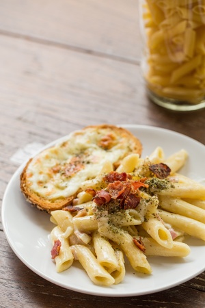 Penne Pasta with Ham and Cheese on wooden table, Italian Cuisineの写真素材