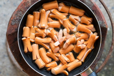 making hot dog on stoveの写真素材