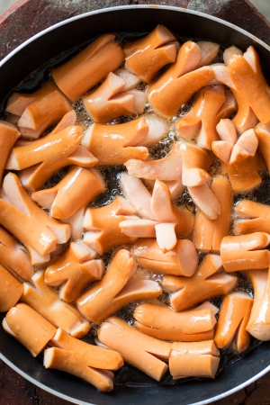making hot dog on stoveの写真素材