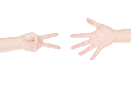female hand making scissors and paper, playing rock scissors paper  isolated on whiteの写真素材