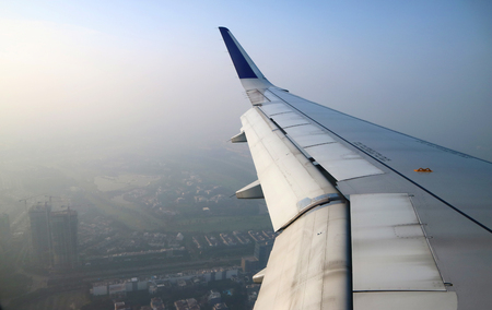 Arial view from internal cabin of aeroplane. View with wing of aeroplane in imageの写真素材