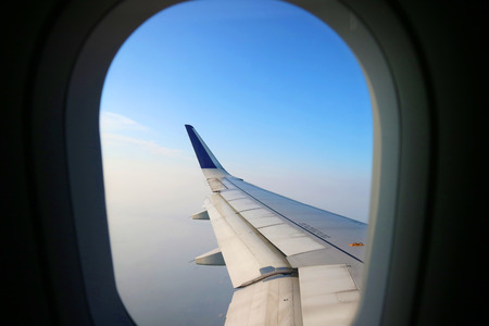 View from an aeroplane windows with an airoplane wing in the corner