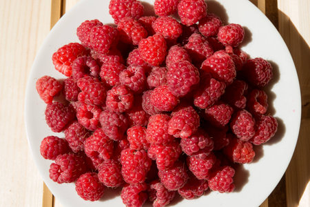 Top view of fresh raspberry on wooden boardsの写真素材