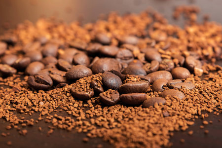 Coffee beans and ground coffee on a dark brown tableの写真素材