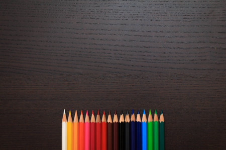 Color pencils on a dark background with space for textの写真素材