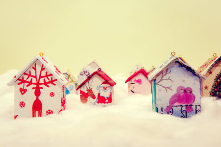 Fir tree decoration: handmade houses with Christmas ornaments in wool simulating snowの写真素材