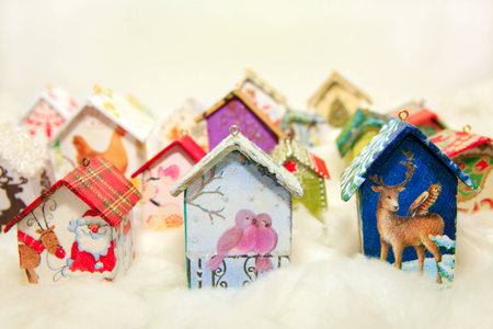 Fir tree decoration: handmade houses with Christmas ornaments in wool simulating snowの写真素材