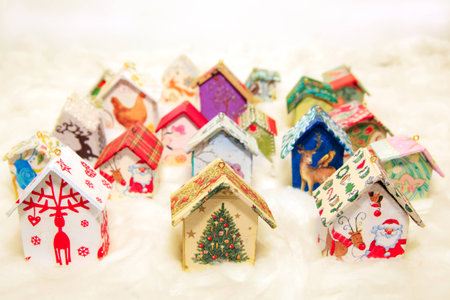 Fir tree decoration: handmade houses with Christmas ornaments in wool simulating snowの写真素材