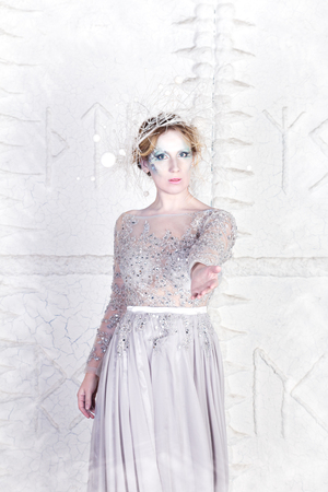 Beautiful winter snow queen on a white backgroundの写真素材