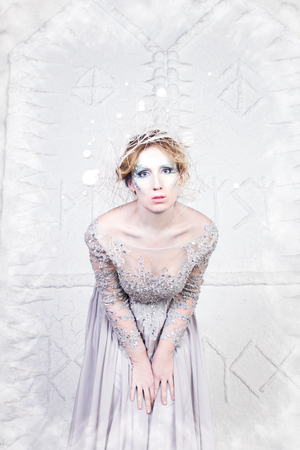 Beautiful winter snow queen on a white backgroundの写真素材