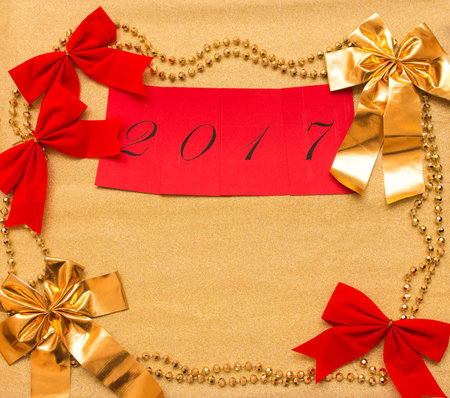 New year and Christmas background of gold paper and decorations with space for your textの写真素材