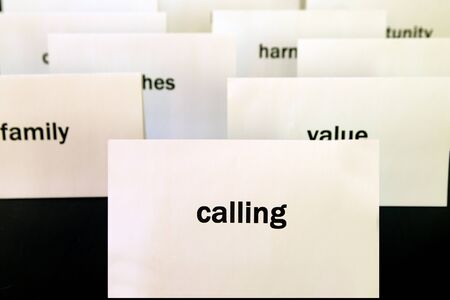 Word Calling on a white paper card surrounded by other words. Priorities and values conceptの写真素材