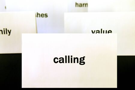 Word Calling on a white paper card surrounded by other words. Priorities and values conceptの写真素材
