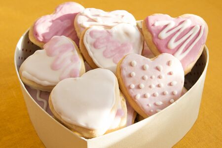 White and pink cookies with frosting in the shape of a heart in a box. Valentine's Dayの写真素材