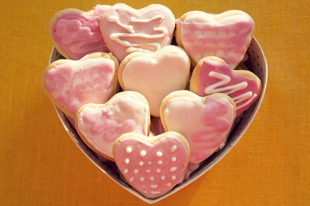 White and pink cookies with frosting in the shape of a heart in a box. Valentine's Dayの写真素材