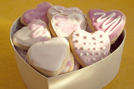 White and pink cookies with frosting in the shape of a heart in a box. Valentine's Dayの写真素材