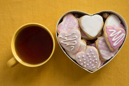 Ð¡up of tea and cookies with frosting in the shape of a heart. Valentine's Dayの写真素材