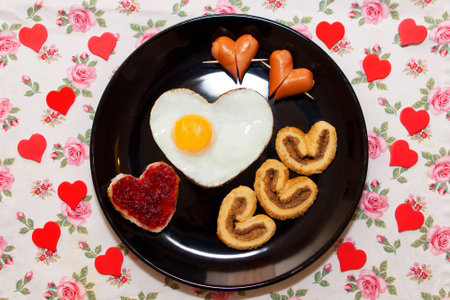 Breakfast with biscuits, sandwich with jam, sausage and scrambled egg in a heart shape. Valentine's Dayの写真素材