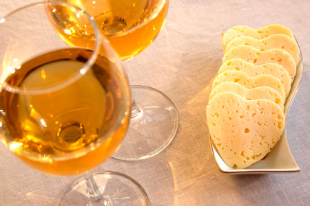 Heart shaped cheese and two glasses of  white wine. Valentine's Day の写真素材
