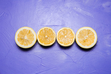 Halves of  lemons on a lilac background. Top viewの写真素材