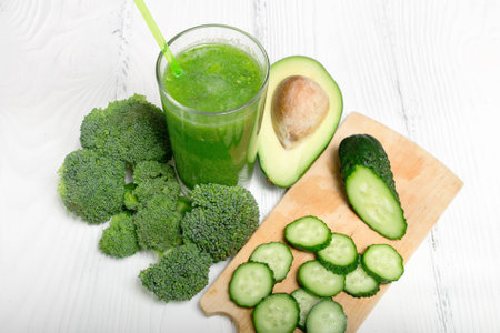 Green smoothie from broccoli, avocado and cucumber with ingredientsの写真素材