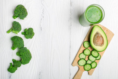 Green smoothie from broccoli, avocado and cucumber with ingredients with space for textの写真素材