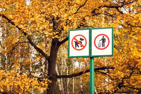 Prohibiting dog sign and prohibiting littering sign in forest. Nature pollution conceptの写真素材