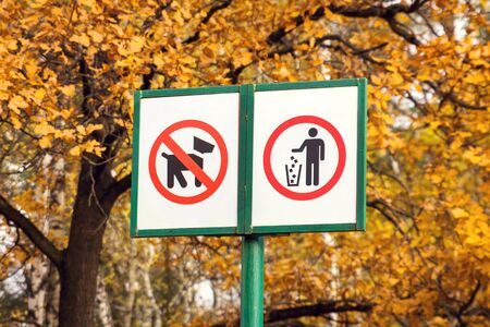 Prohibiting dog sign and prohibiting littering sign in forest. Environmental pollution conceptの写真素材