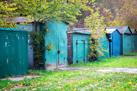 Row of old metal, wooden and brick green and blue garagesの写真素材