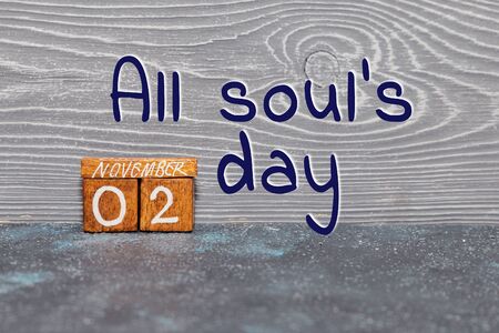 Old vintage wooden calendar representing November 2 on a gray background and inscription All soul's dayの写真素材