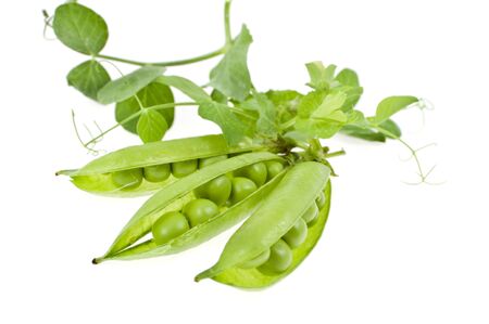 a pea is green in a pod with leaves on a white backgroundの写真素材
